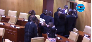 Some Minority MPs holding placards with the inscription 'bloody widow'