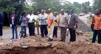 The minister and his team inspecting the collapsed bridge at Tinkong