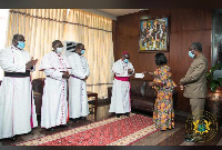 Chief of Staff, Frema Opare receiving the cheque from the bishops