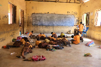 Some students lying down to write