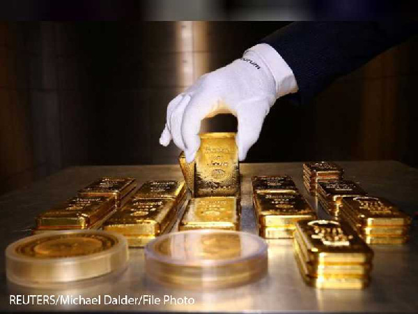 Gold bars and coins are stacked in the safe deposit boxes room of the Pro Aurum gold house in Munich