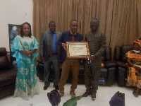 Prophet Obotuo (M) displaying his award