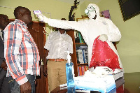 A health officer screens visitors at Nakuru County's health offices