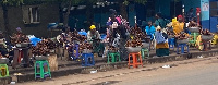 Hawkers seated idly behind their wares