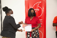 From (R) CEO of Vodafone presenting a certificate to a teacher