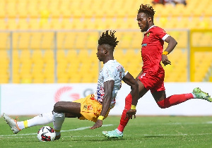 Hearts of Oak's Konadu Yiadom(white) in action against Kotoko's Steven Mukwala