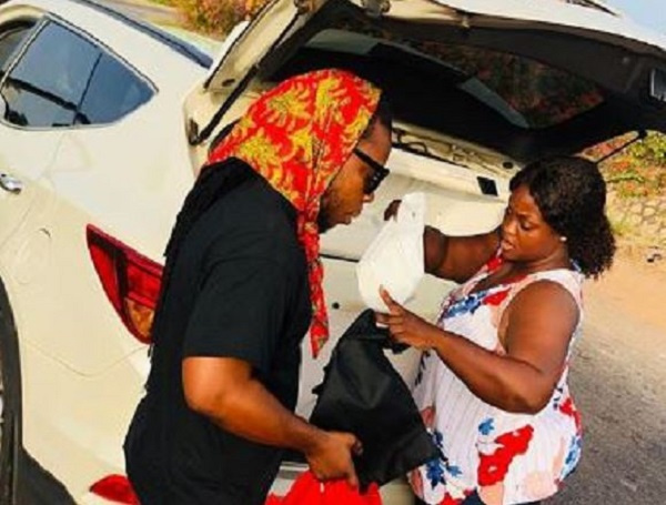 Edem and his wife Stacy sorting out food for the security personnel