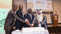 The Ambassador assisted by other dignitaries cutting cake at the event