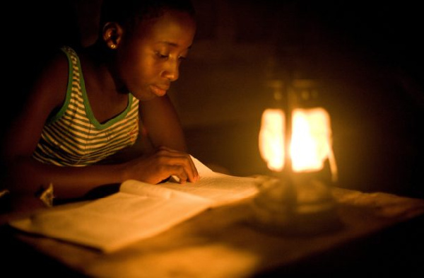 A student studying with a lantern due to a power outage