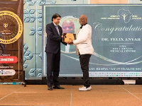 Dr. Felix Anyah [in white suit] receiving his award