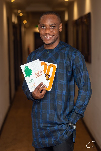 Prince Adu-Appiah displays his books