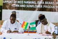 Rev. George Tsidi Blavo and Bashiru Ibrahim signing the MoU