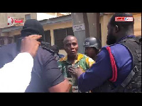 Gregory Afoko being escorted by Police personnel