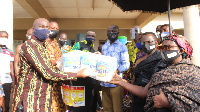 CEO of GIADEC handing some of the items over to leaders of the beneficiary towns