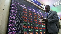 Nairobi Securities Exchange employee checks the stock trading on board at the NSE head offices