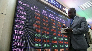 Nairobi Securities Exchange employee checks the stock trading on board at the NSE head offices