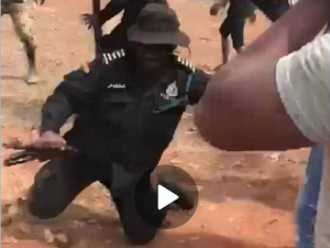 An officer  was shoved by the mob and pushed to the ground