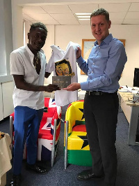 Shatta Wale presented a Shatta Movement T-Shirt, and copies of his songs to Iain Walker