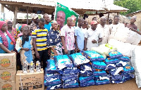 NDC PC for Kumbungu constituency Dr. Hamza Adam presenting relief items