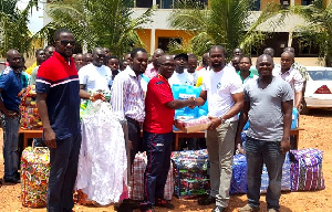 Ayernor (2nd R) presenting one of the items to Pastor Fennie