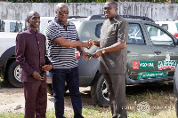 Former President Mahama (middle) donating the cars to the Chairman and general secretary of NDC