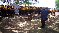 Acting District Director of the NCCE, Mr. Samuel Akolgo with some students