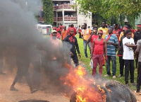 Demonstrators burning tyres at the premises of the Assembly