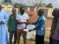 Some old students presenting the cheque to the school