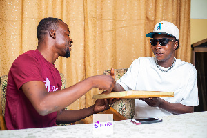 Wiz Child receiving the plaque from Mr. Akundaare Paul Awinbisa