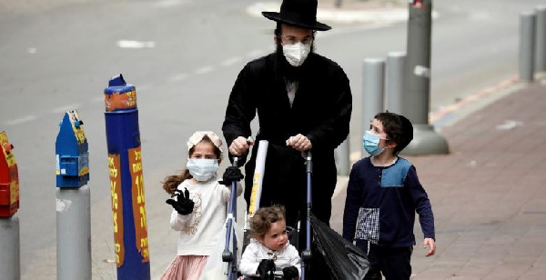 Women with three kids walking