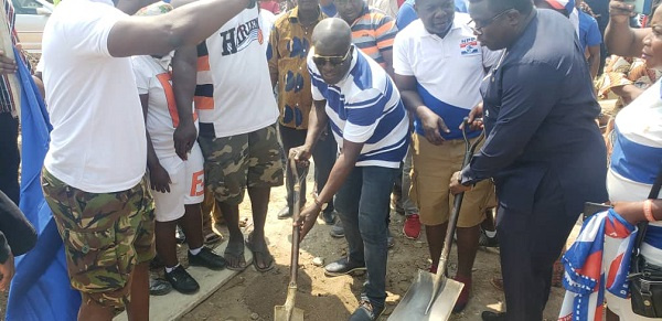 Titus Glover, Deputy Minister for Transport cutting the sod for the commencement of the office