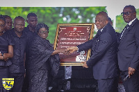 Rev Wengam handing over a citation to Mrs Annan at the burial service