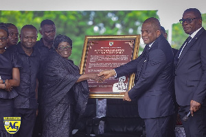 Rev Wengam handing over a citation to Mrs Annan at the burial service