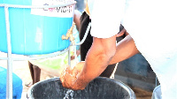 A driver washing his hands with liquid soap at the Navrongo Lorry station