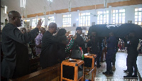 Mahama bidding his late security officer farewell during his burial ceremony