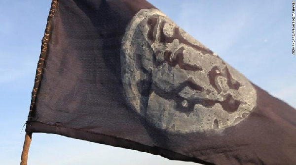 A Boko Haram flag flutters from an abandoned command post in Gamboru