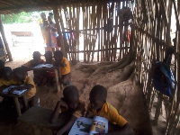 Students learning in bamboo structure