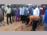 Professor Kwesi Yankah cutting sod for the construction of 4 separate school projects