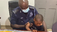 A photo of the boy with a police officer