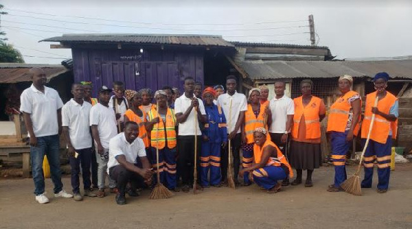 The Atiwa East NABCO trainees in a group photo after the clean up exercise