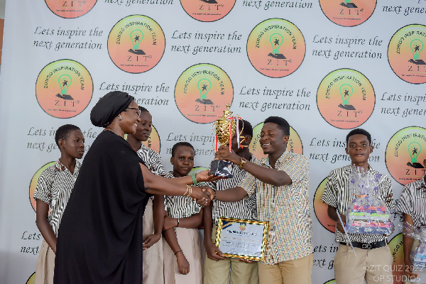 Joyce Bawah Mogtari hands over the trophy to Kwame Nkrumah Memorial