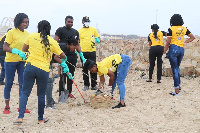 A group of UMB staff gathering litter for disposal