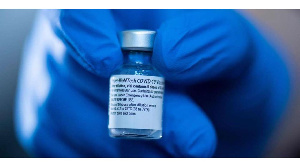 A pharmacist holds a vial containing the Pfizer-BioNTech vaccine, PHOTO | AFP