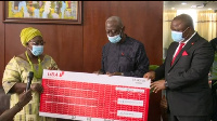 Chief of Staff, Frema Osei Opare receiving the cheque from Senior Executives of UBA Ghana