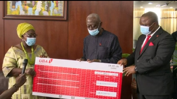 Chief of Staff, Frema Osei Opare receiving the cheque from Senior Executives of UBA Ghana