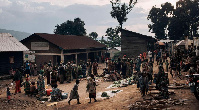 War-displaced women gather at a small roadside market in the Kalinga IDP camp