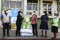 WFP Rep & Country Director - Rukia Yacoub handing over a bag of Maisoya specialized nutritious food