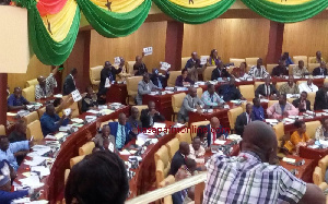 MPs in Parliament holding placards during the presentation of the 2017 Budget