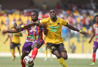 Hearts of Oak's Dennis Korsah(L) battles Asante Kotoko's George Mfegue(R)