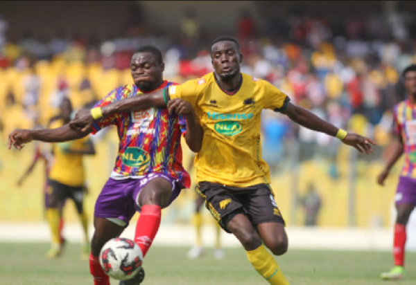 Hearts of Oak's Dennis Korsah(L) battles Asante Kotoko's George Mfegue(R)